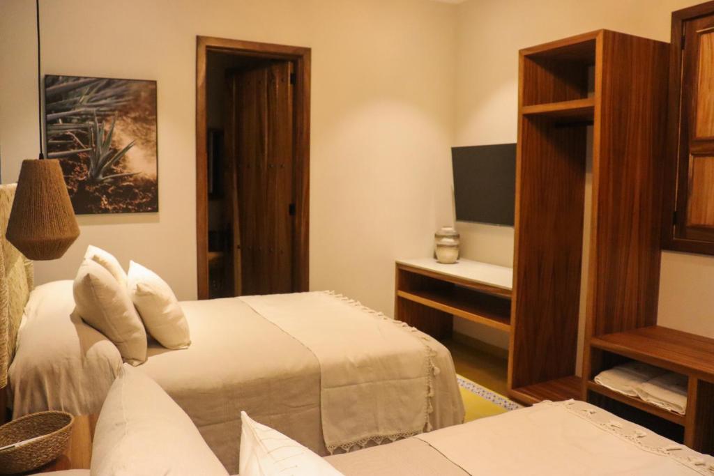 Postel nebo postele na pokoji v ubytování Hotel Boutique Gloriagave