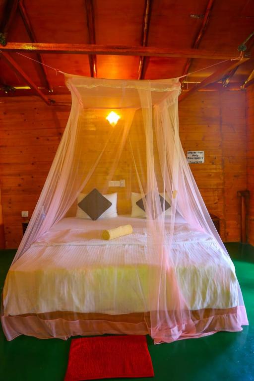 Postel nebo postele na pokoji v ubytování Ella Bamboo Cabana