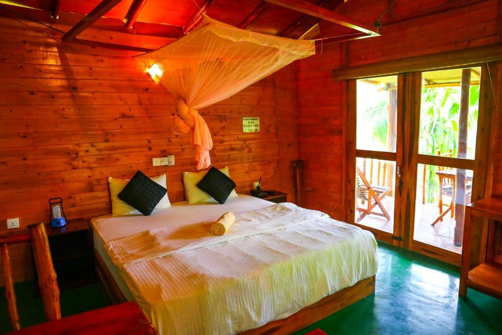 Postel nebo postele na pokoji v ubytování Ella Bamboo Cabana