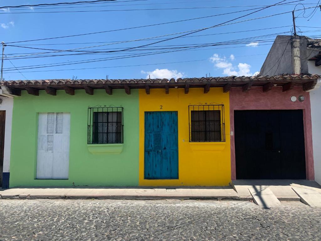 a colorful house with two doors on a street at La 4ta Hostal in Antigua Guatemala