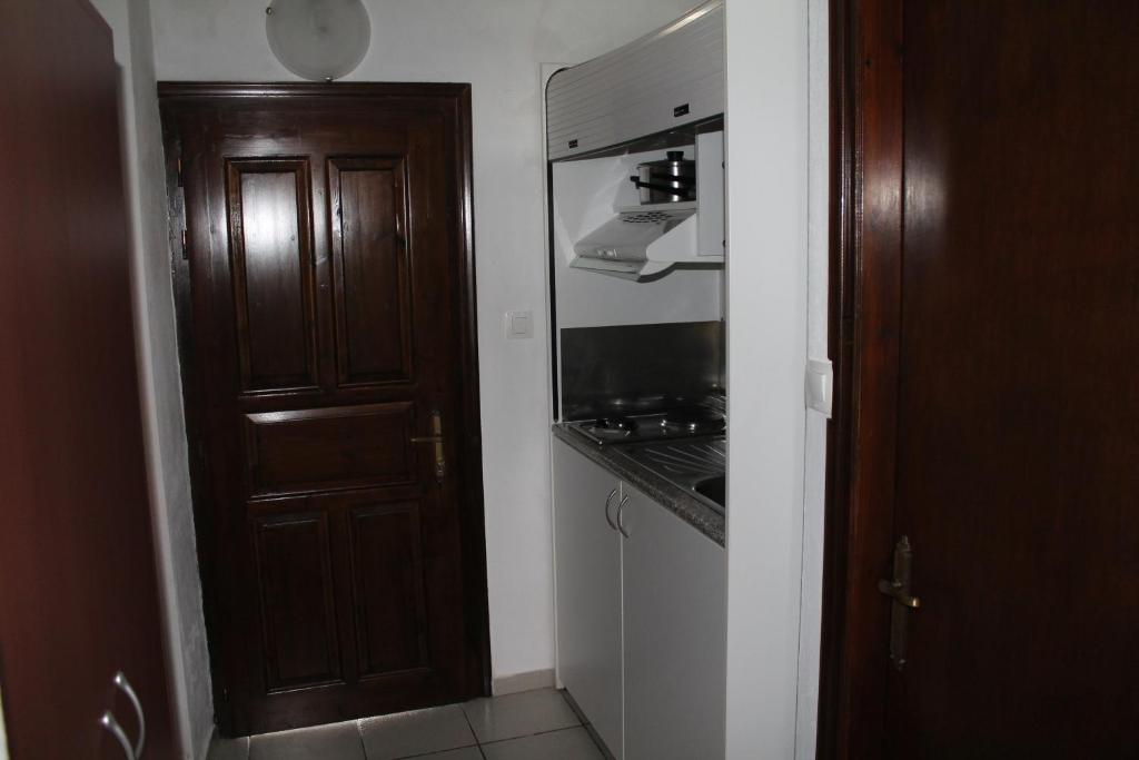 Il comprend une cuisine équipée d'une cuisinière. four supérieur à côté d'une porte dans l'établissement Villa Frideriki, à Agia Paraskevi