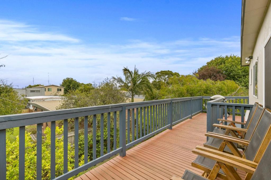 a balcony with two chairs and a blue railing at THE Beach Hive - Wifi, PET Friendly Outside Only - Inlet Side in Inverloch