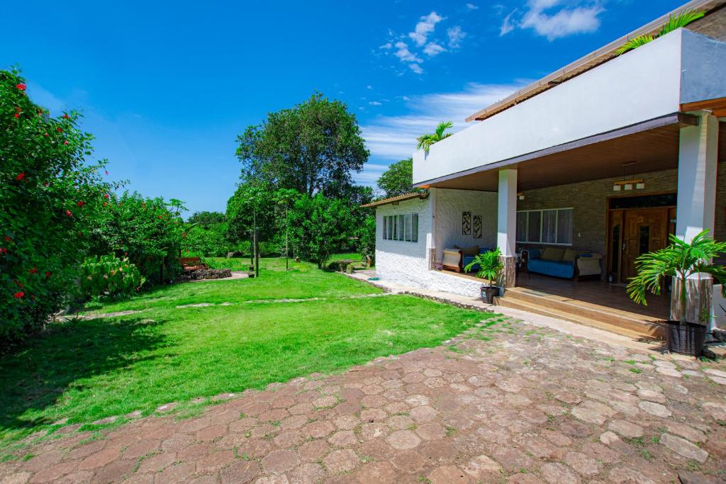 a house with a patio and a yard at Amancay House in San Cristóbal