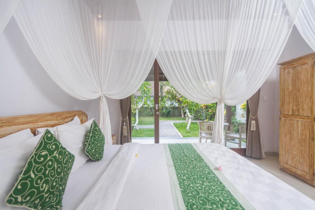 Postel nebo postele na pokoji v ubytování Parthi Puri Ubud