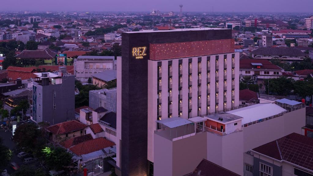 een hoog gebouw met een klok aan de zijkant bij REZ Hotel in Semarang