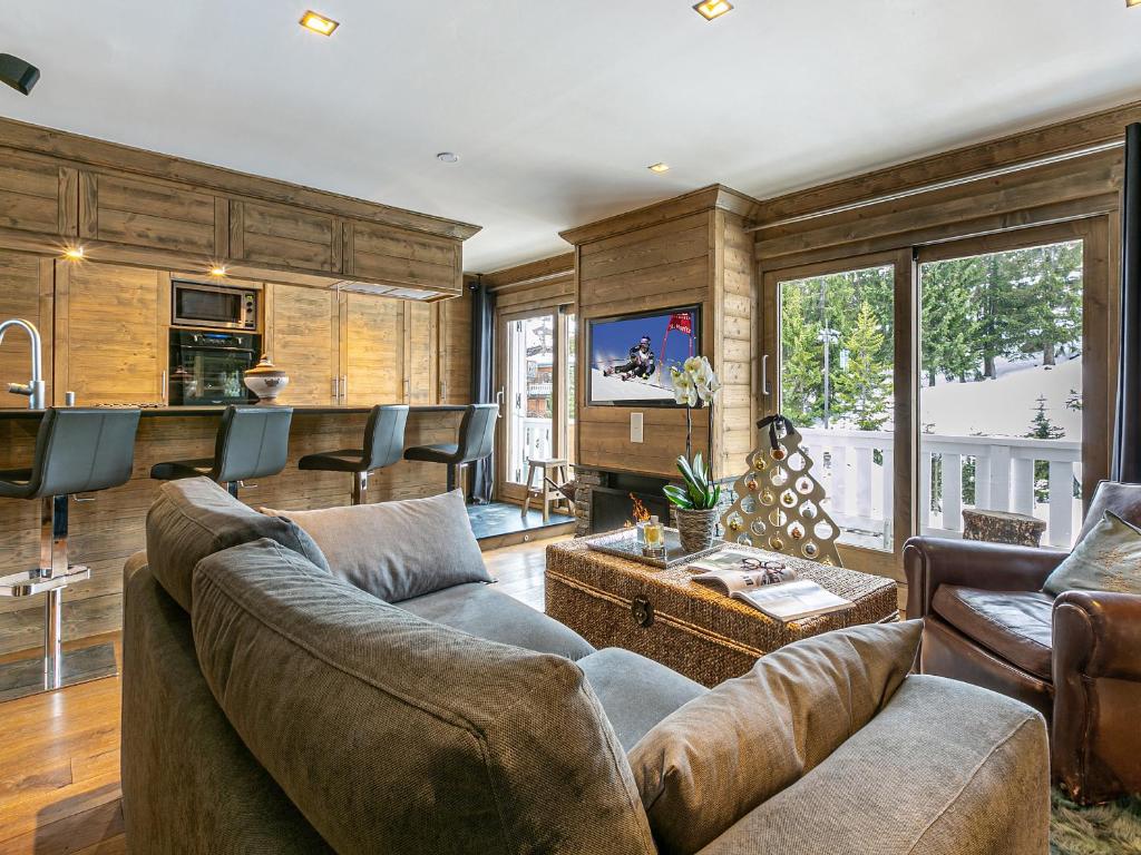 a living room with a couch and a table at Appartement élégant à Courchevel avec 3 chambres et service de conciergerie - FR-1-613A-12 in Courchevel