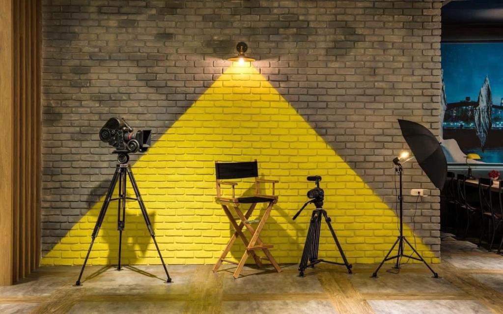 a yellow brick wall with cameras and a light on it at 凝萃文旅 台中車站店 NCH-Business Hotel in Taichung