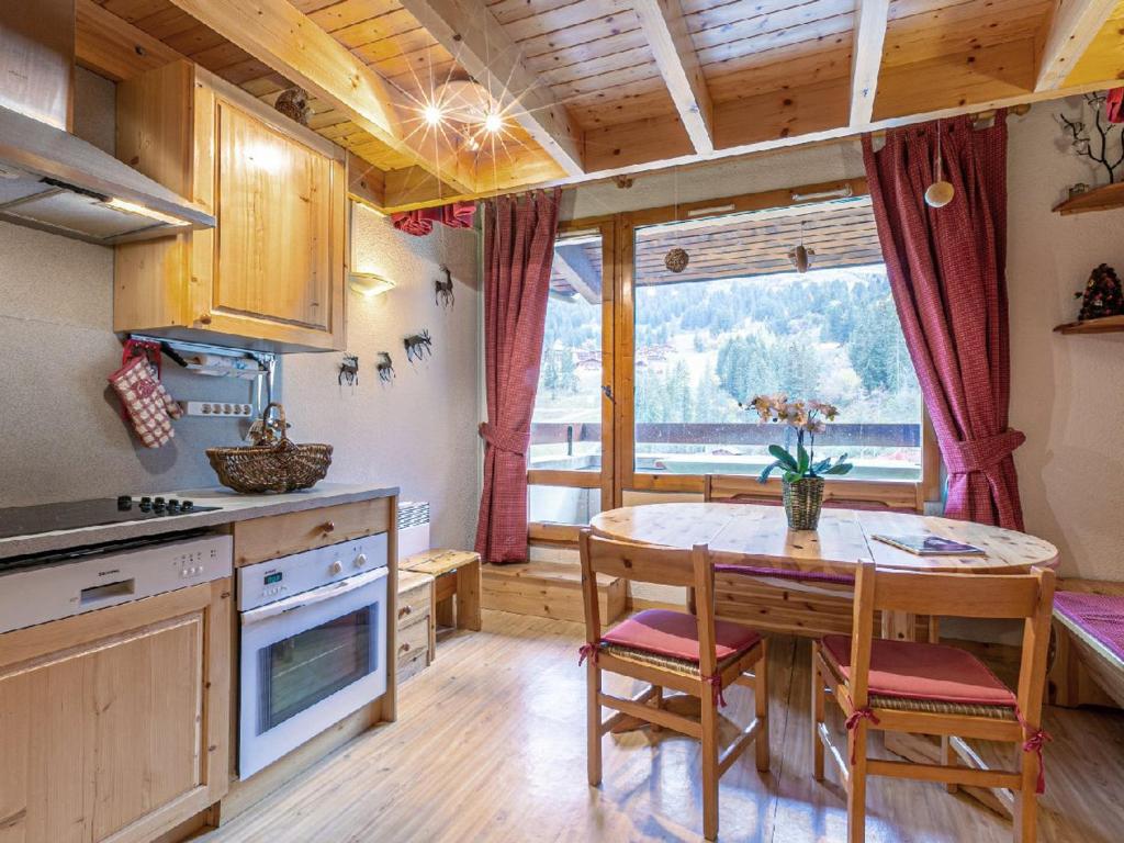 a kitchen with a table and chairs and a large window at Appartement Valmorel, 3 pièces, 6 personnes - FR-1-356-395 in Valmorel