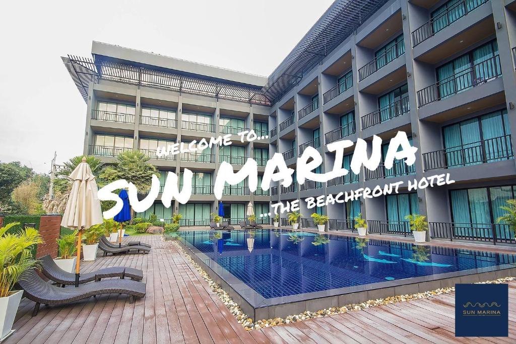 a hotel with a swimming pool in front of a building at Sun Marina Cha-Am in Cha Am
