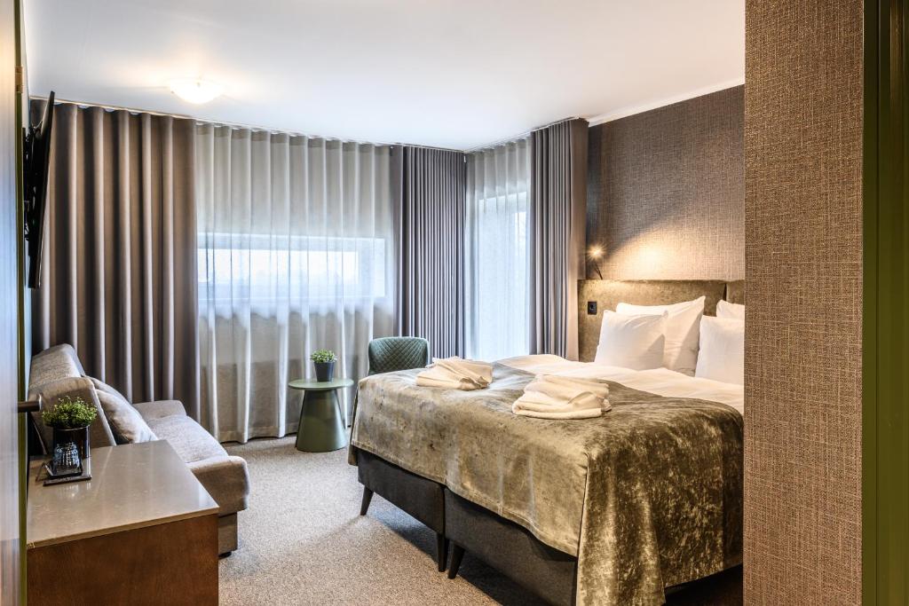 Postel nebo postele na pokoji v ubytování Ugandi Hotel