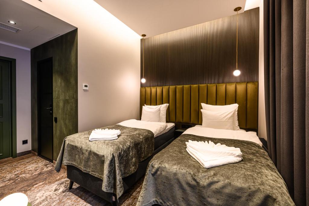 Postel nebo postele na pokoji v ubytování Ugandi Hotel