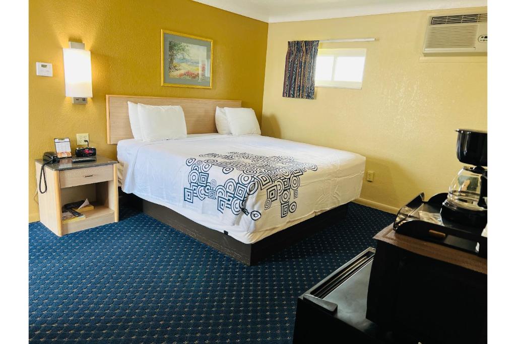 um quarto de hotel com uma cama grande num quarto em Budget inn motel perrysburg oh em Millbury