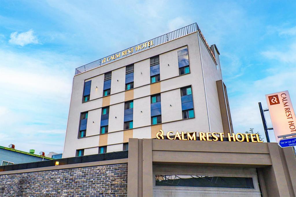 a building with a sign on the front of it at Calm Rest Hotel Busan Sasang in Busan