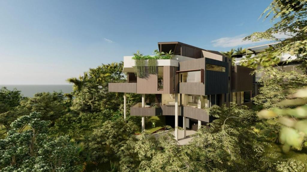 an apartment building on a hill with trees at Moonrise & Starfall in Byron Bay