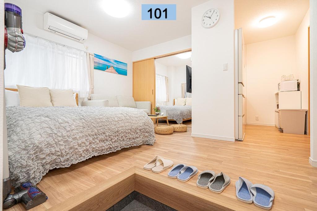 1 dormitorio con 1 cama y 2 pares de zapatos en Shinjuku area/Family-apartment/4 min to Subway, en Tokio