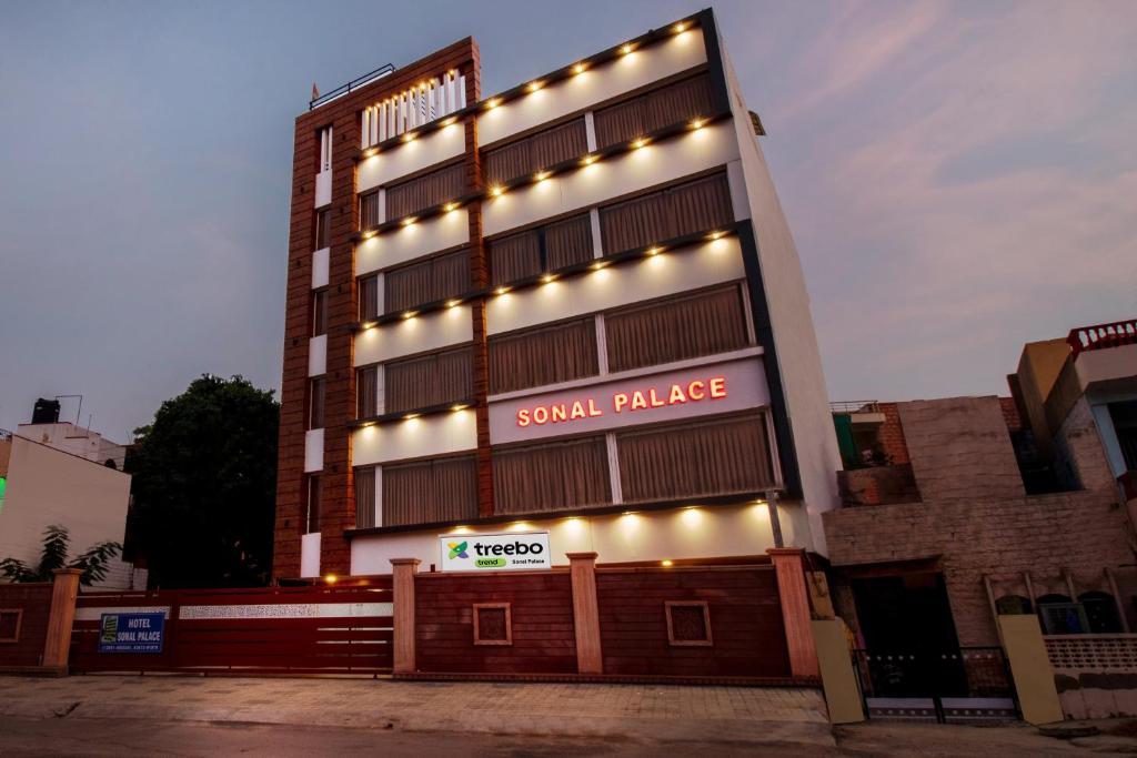 a large building with lights on the side of it at Treebo Trend Sonal Palace 1 Km From Jodhpur Airport in Jodhpur