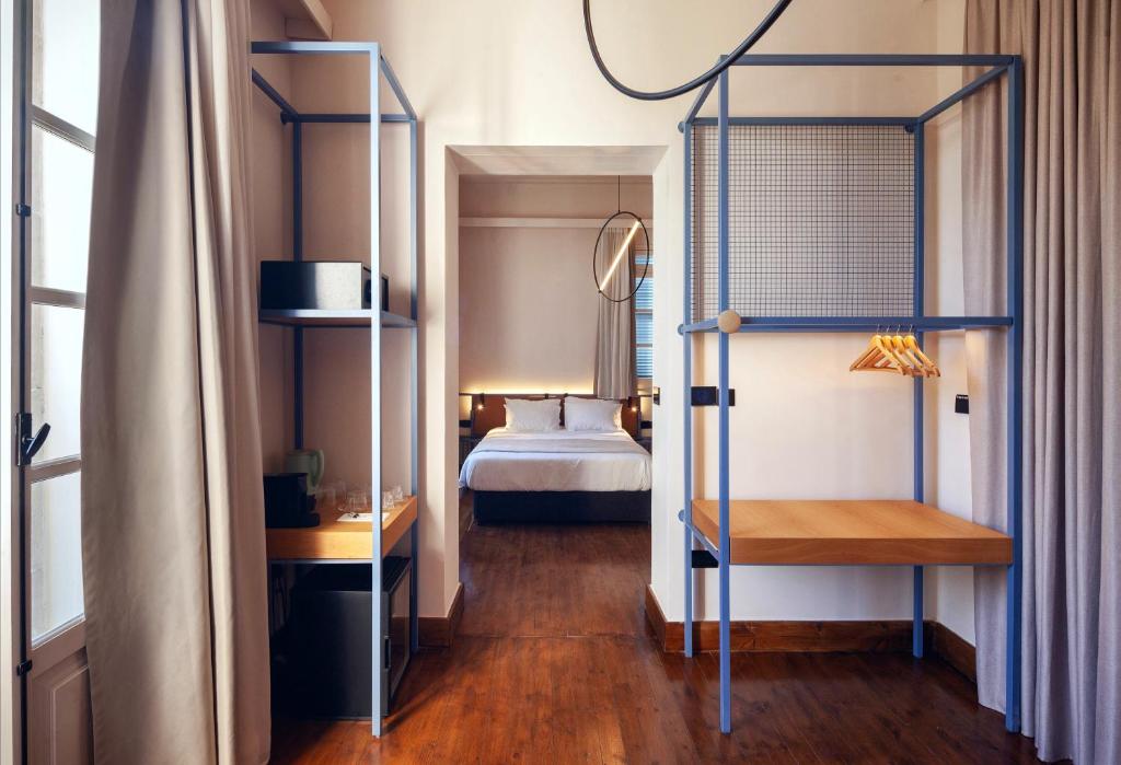 Postel nebo postele na pokoji v ubytování Heart Hotel