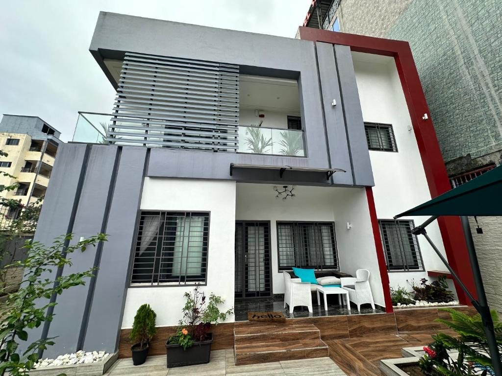 a house with a balcony with a table at Villa Only in Douala