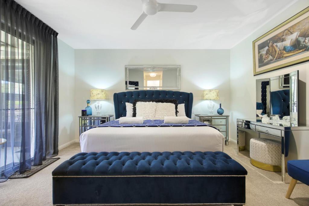 a bedroom with a large bed and a large window at Casa Bella 3 Bedroom in Coffs Harbour