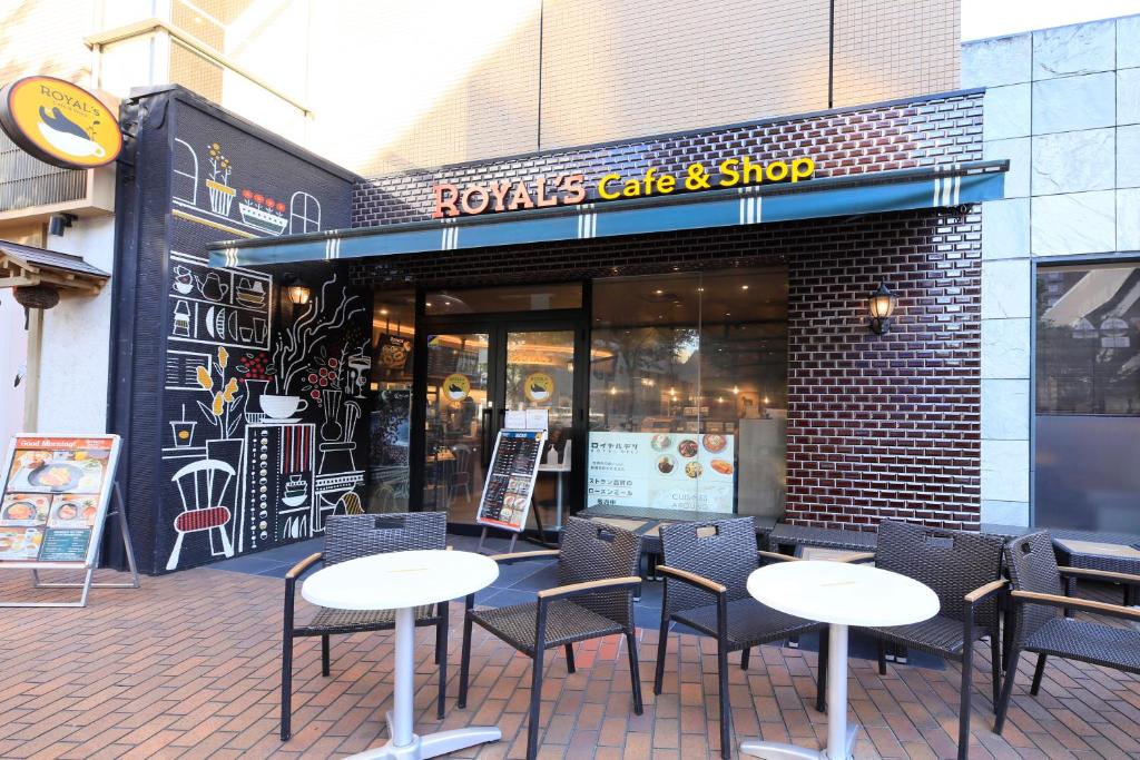 a group of tables and chairs in front of a store at Richmond Hotel Yokohama-Bashamichi in Yokohama