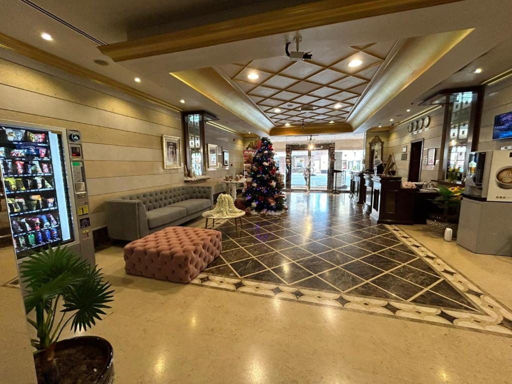 a lobby with a christmas tree in the middle at Al Raya Hotel Apartments in Dubai