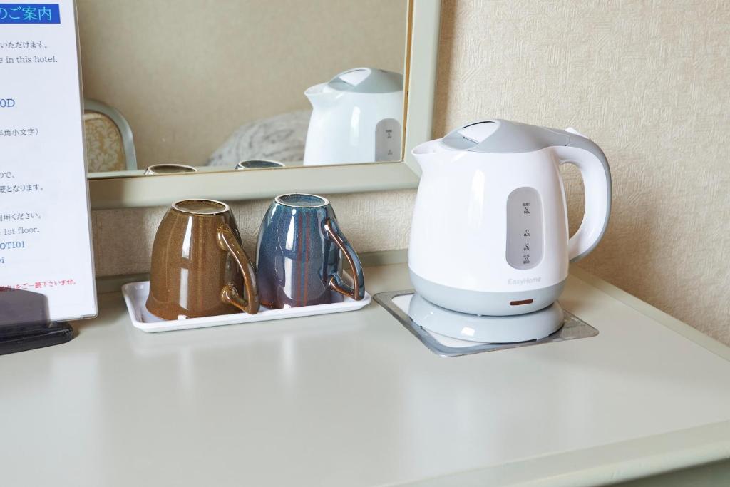 Příslušenství pro přípravu čaje a kávy v ubytování Hotel Machida Villa