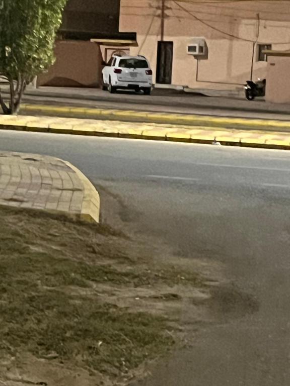 um carro branco estacionado ao lado de uma rua em شقه فاخره em Al Wajh