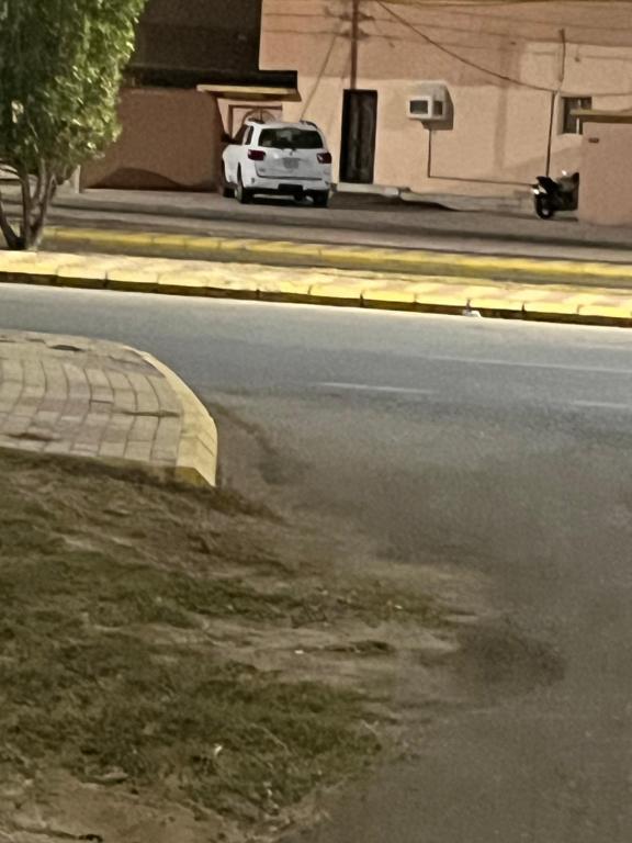 a white car parked on the side of a street at شقه فاخره in Al Wajh