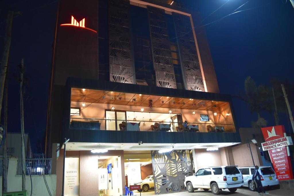 a building with a sign on top of it at night at Millennium Terrace Hotel in Kampala