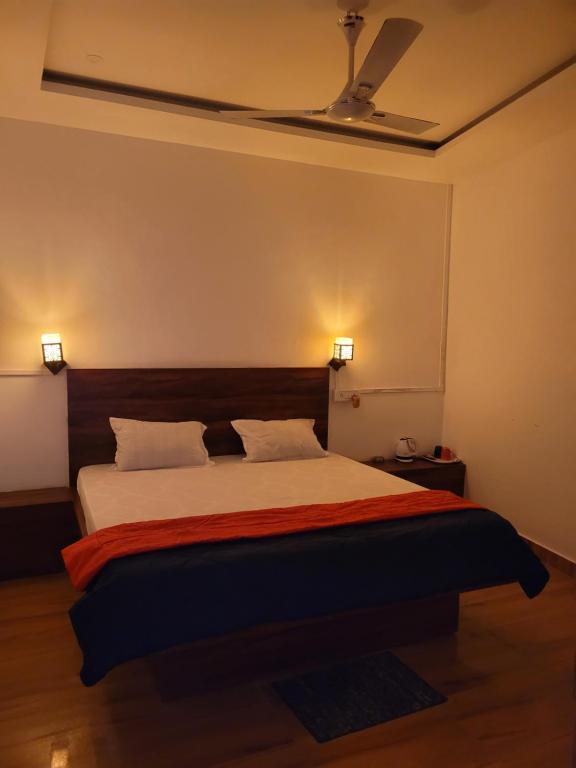 a bedroom with a large bed with a ceiling at Dream Lodging in Silchar