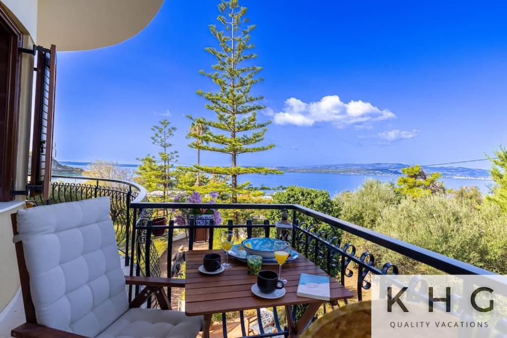 a balcony with a table and a tree on it at Théa Lassi 2 bedroom apartment, First floor in Argostoli