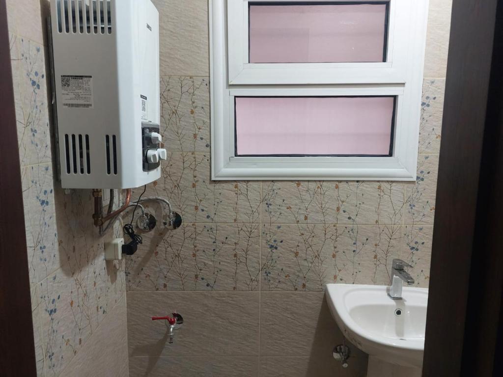 a bathroom with a window and a sink at Happy Transit in Cairo