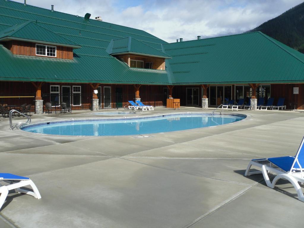 a large swimming pool in front of a building at Sunshine Valley RV Resort and Cabins in Sunshine Valley