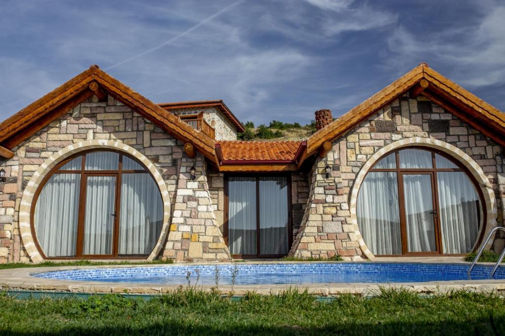 a rendering of a house with large windows at Amazing Stone House with Private Pool in Iznik in İznik