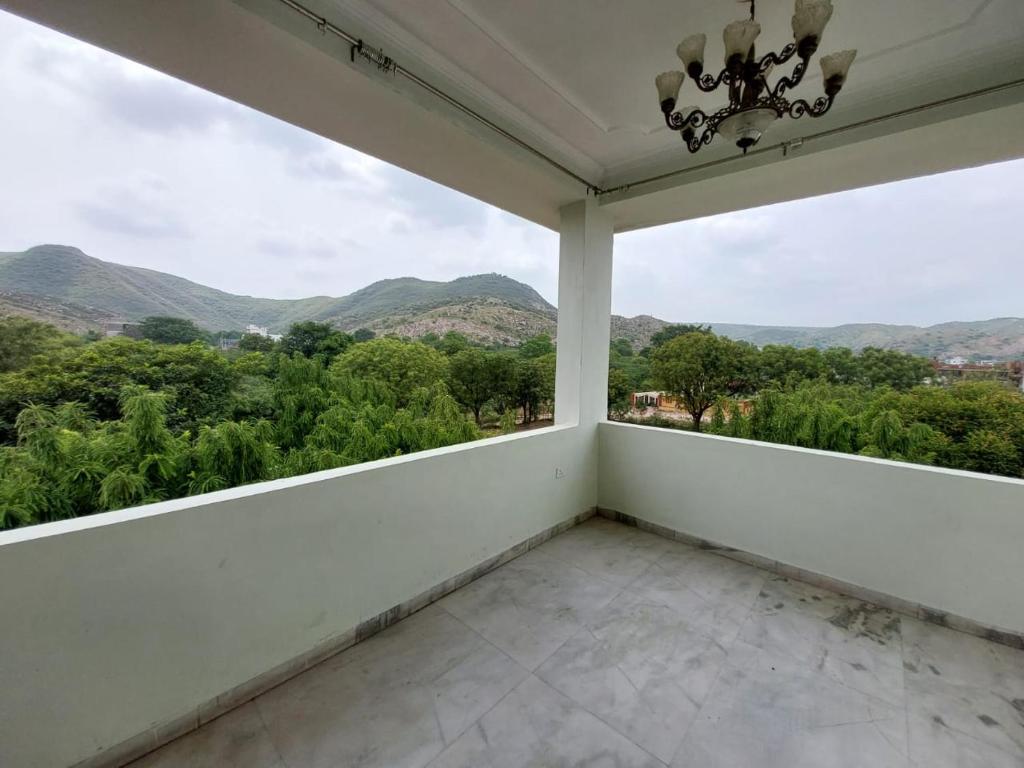 a balcony with a view of the mountains at JHALANA RETREAT RESORT in Jaipur