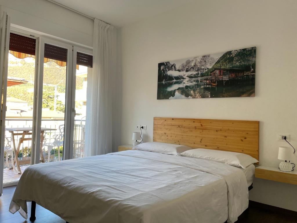 a bedroom with a large bed and a large window at Nest & Relax in Trento