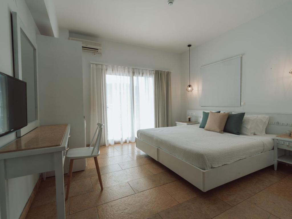 Postel nebo postele na pokoji v ubytování Dracos Hotel