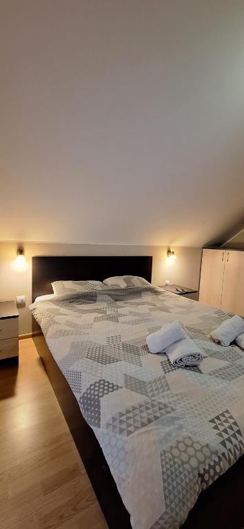 a large bed in a room with a large white bedspread at Apartments Katarina in Zlatibor