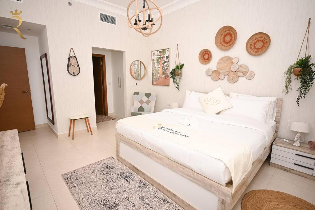 a bedroom with a large white bed in a room at Yas Natura Bliss 1BR Apartment in Abu Dhabi