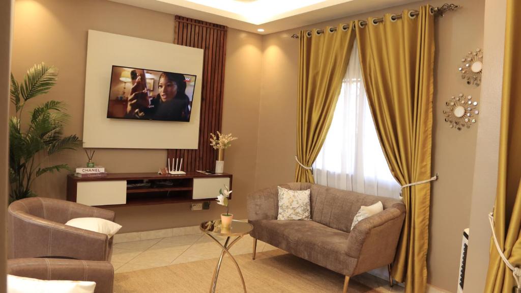 a living room with a couch and a chair at Premier Suites Kyanja in Kampala