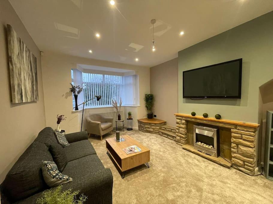 a living room with a couch and a fireplace at Modern Spacious 5 Bed House in Newcastle in Newcastle upon Tyne