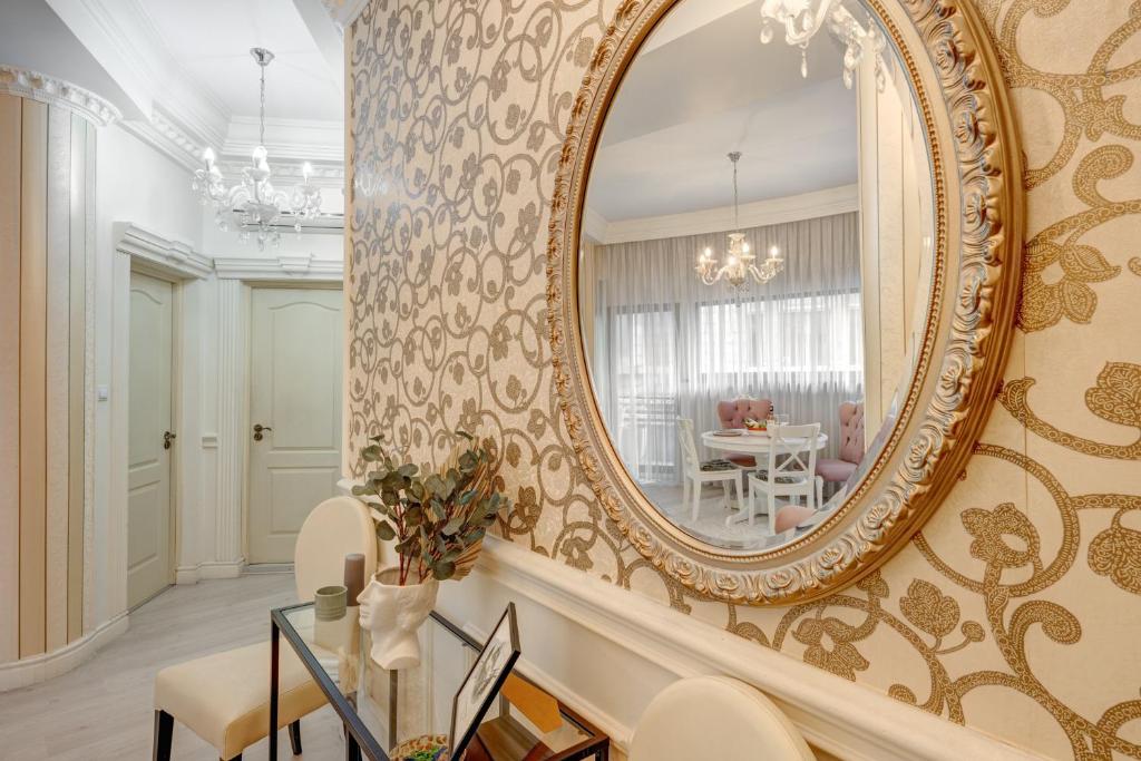 a large mirror on the wall of a living room at Beautiful 2BedFlatCismigiu in Bucharest