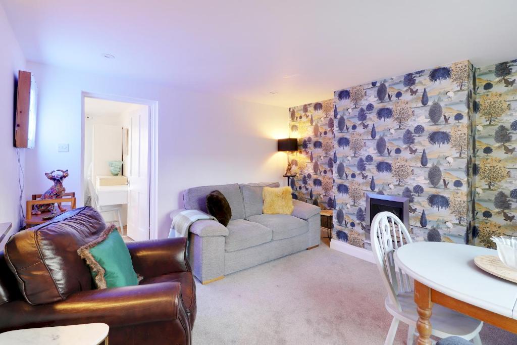 a living room with a couch and a fireplace at Pass the Keys Cute flat in Tonbridge in Tonbridge