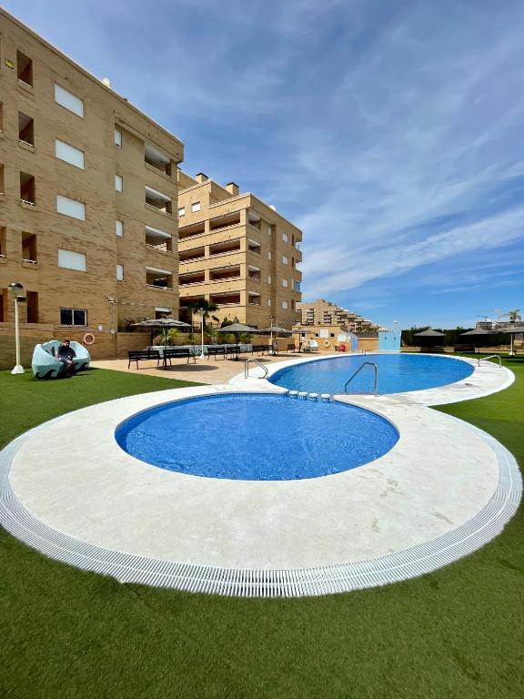 a large swimming pool in front of a building at Apartment Costa Azahar II Ref 012 in El Borseral