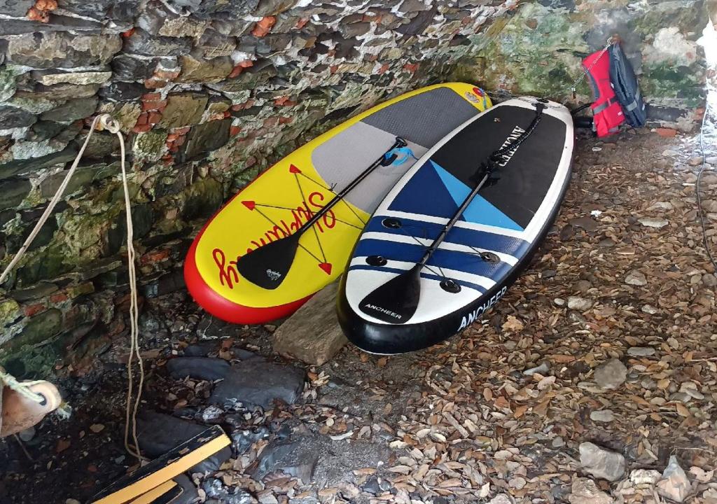 two surfboards sitting next to a stone wall at Casa dell'Arco 31 in Camogli
