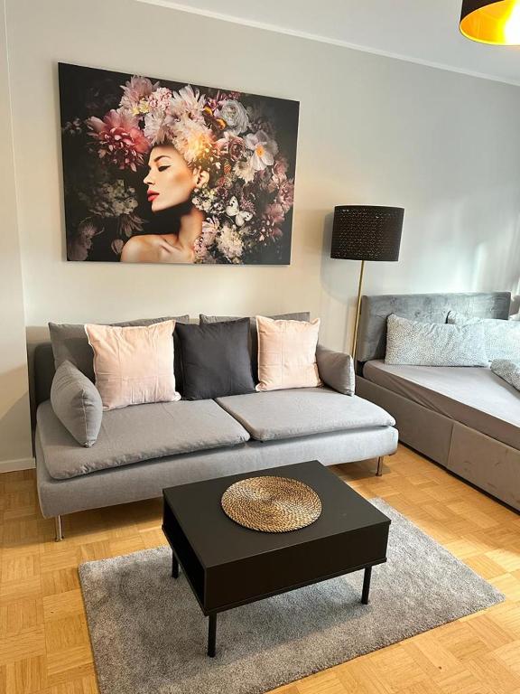 a living room with a couch and a coffee table at AMAROOM apartments 2 in Karlsruhe