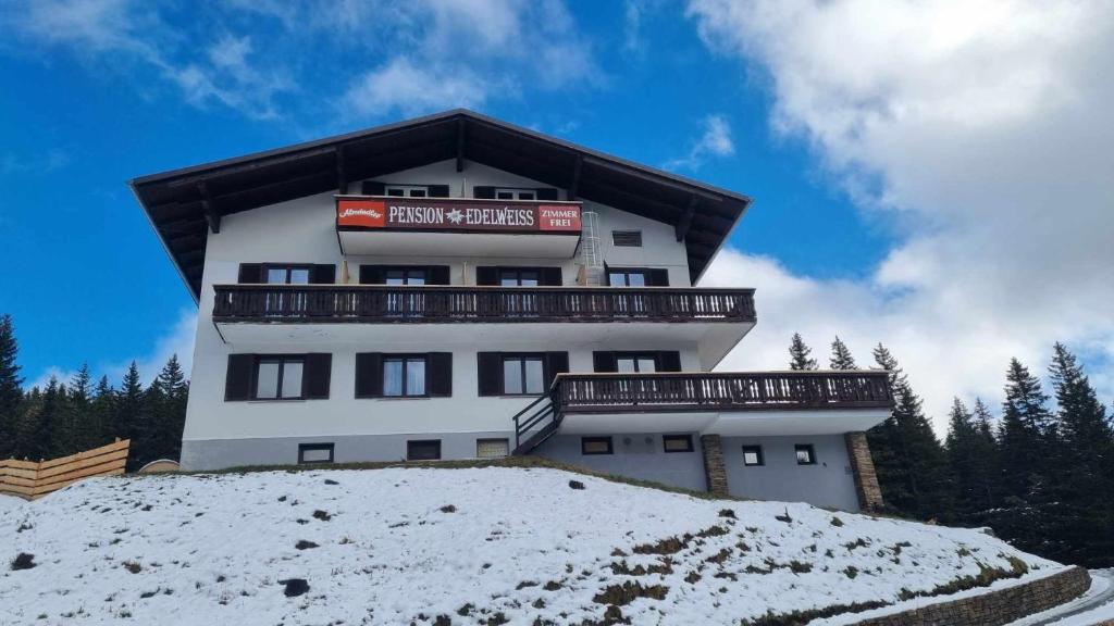 a building on top of a snow covered hill at Pension Bischof Lachtal in Lachtal