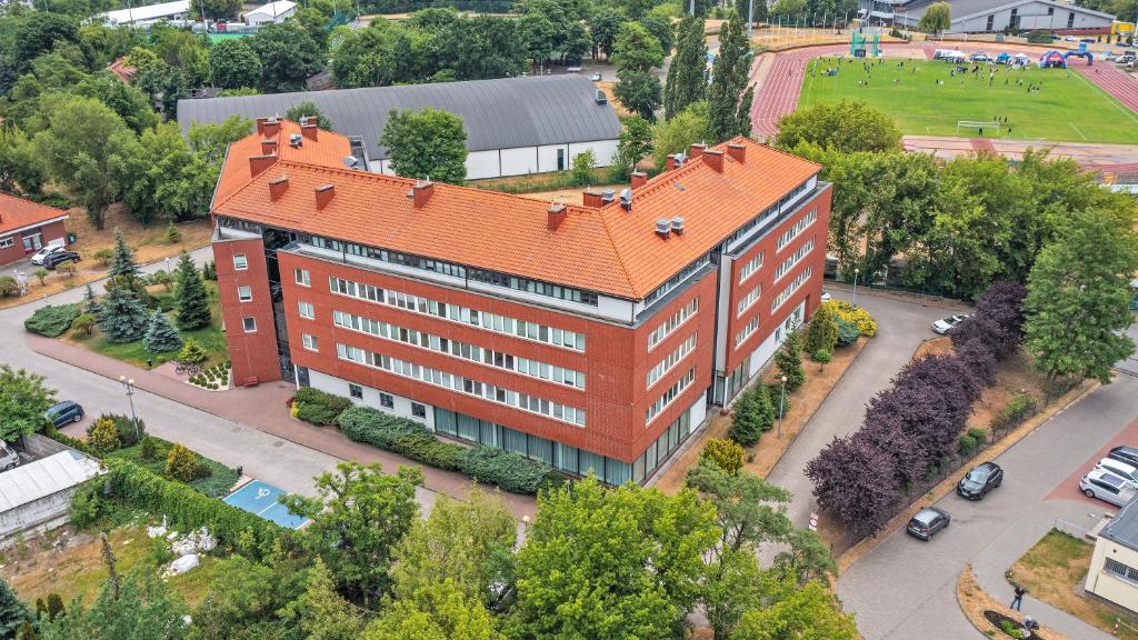 an overhead view of a building with an orange roof at Hotel Uniwersytecki in Toruń