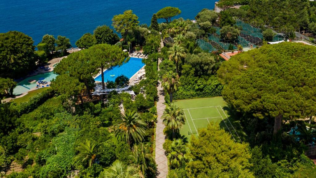 an aerial view of a resort with a pool and trees at Grand Hotel Cocumella in Sant'Agnello