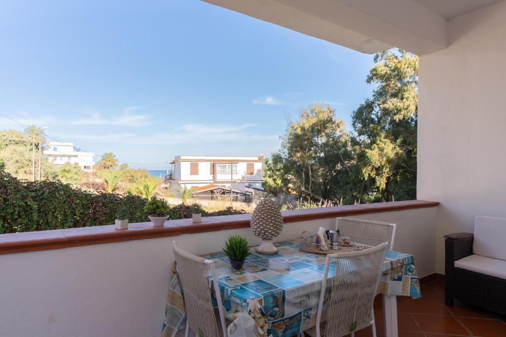 een balkon met een tafel en stoelen en uitzicht op de oceaan bij Conchiglia al Mare in Trappeto
